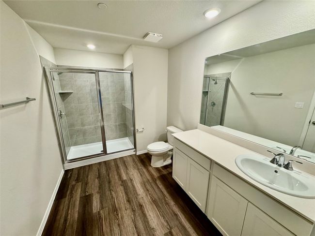 Bathroom with vanity, a stall shower, wood finished floors, recessed lighting, and a textured ceiling | Image 4