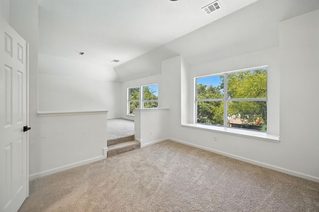 Unfurnished room featuring carpet floors and vaulted ceiling | Image 15