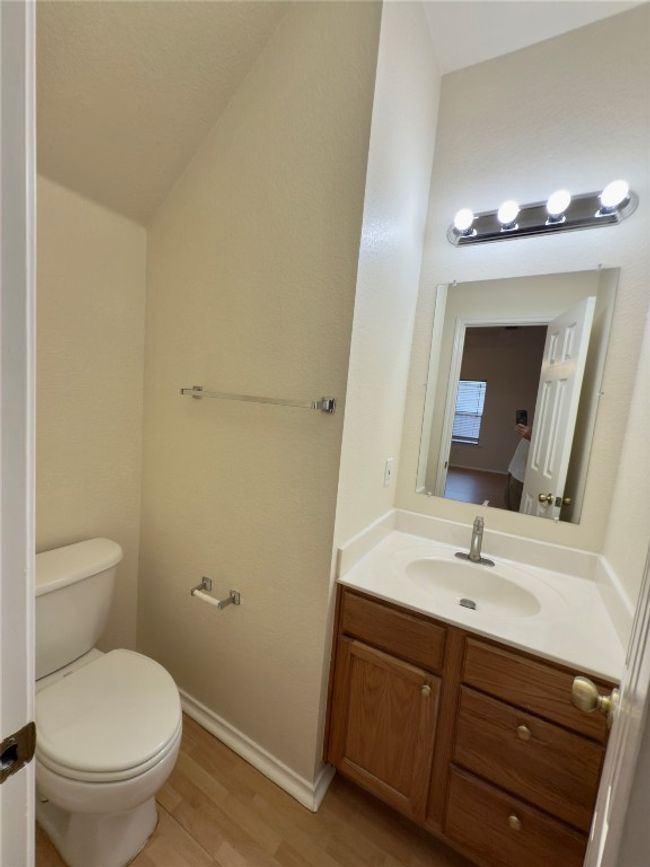 Half bath with vanity, wood finished floors, and vaulted ceiling | Image 35