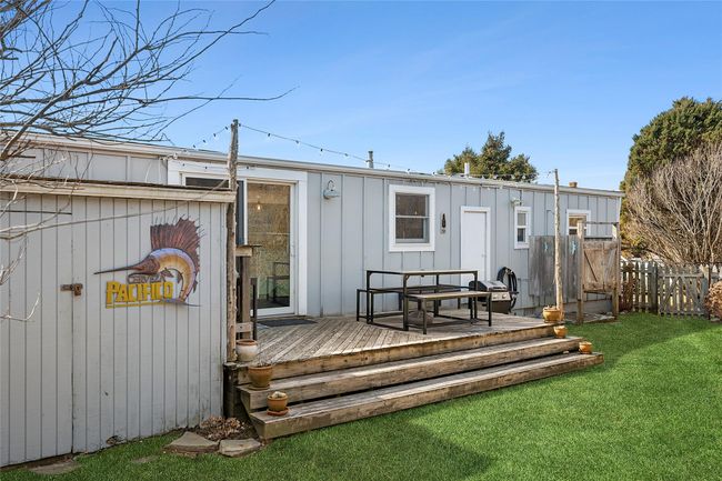 Back of property with a deck, a yard, and fence | Image 14