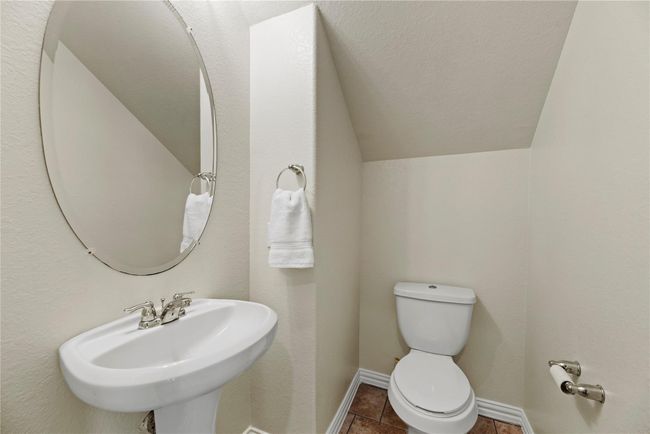 Hospitality is felt throughout the home and the powder room is no exception. Antiqued in style, the lovely pedestal sink is just the right size for visitors and guests. | Image 22