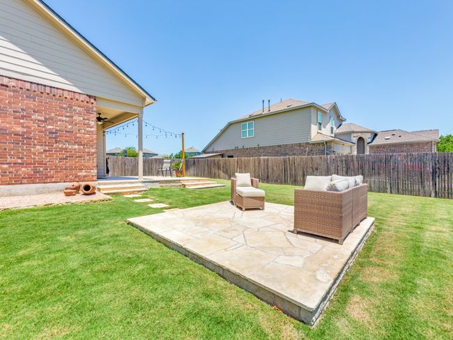 Fenced backyard featuring a patio and ceiling fan | Image 32