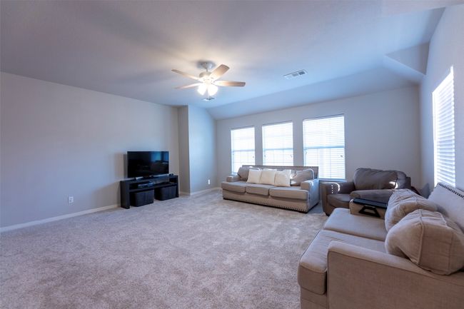 Living room featuring ceiling fan and carpet | Image 28
