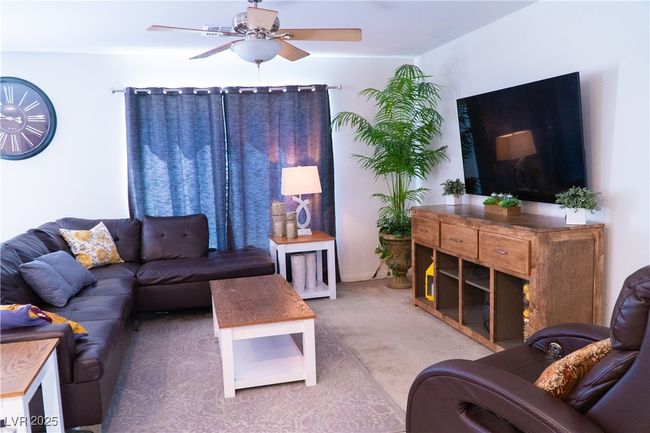 Carpeted living area with ceiling fan | Image 28