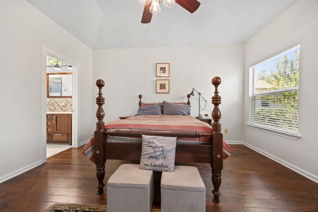 Bedroom featuring hardwood / wood-style flooring, connected bathroom, and ceiling fan | Image 15