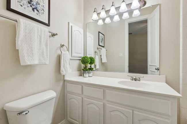 En suite bath has tub with shower, medicine cabinet and nice storage. | Image 23