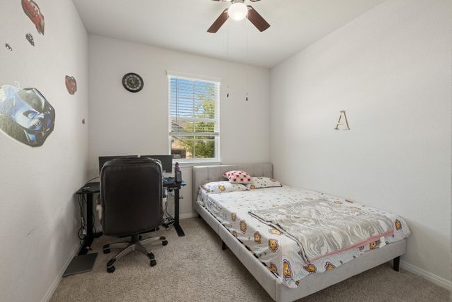 Carpeted bedroom featuring ceiling fan and baseboards | Image 18