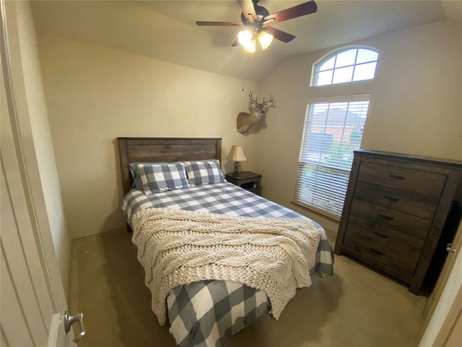 Bedroom featuring ceiling fan, vaulted ceiling, and light carpet | Image 8