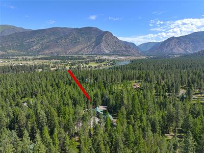 Thompson River Mountains towering behind the Clark Fork River in this beautiful valley. The red arrow points to the property. What a wonderland! | Image 2