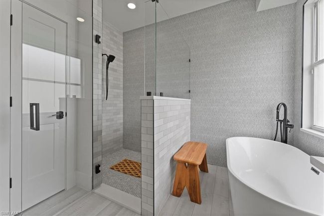 Full bathroom featuring a tile shower, a freestanding tub, and recessed lighting | Image 25