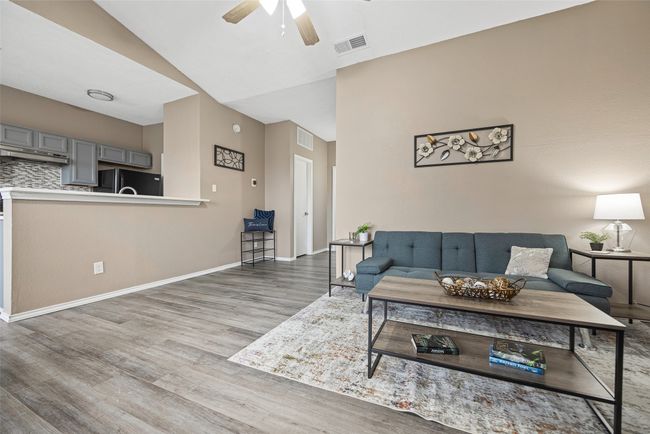 Living room with ceiling fan and LVP flooring | Image 11