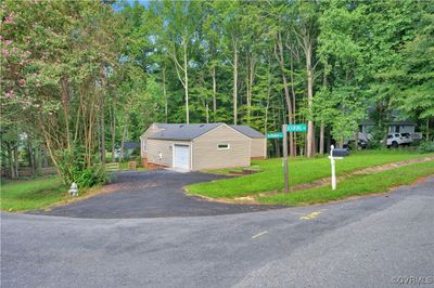 View of front of home featuring an outbuilding, a garage, and a front lawn | Image 3