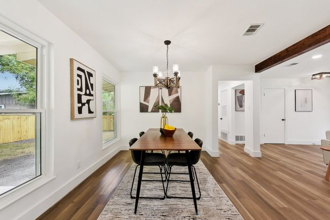 Dining space with visible vents, baseboards, a chandelier, and dark wood finished floors | Image 13