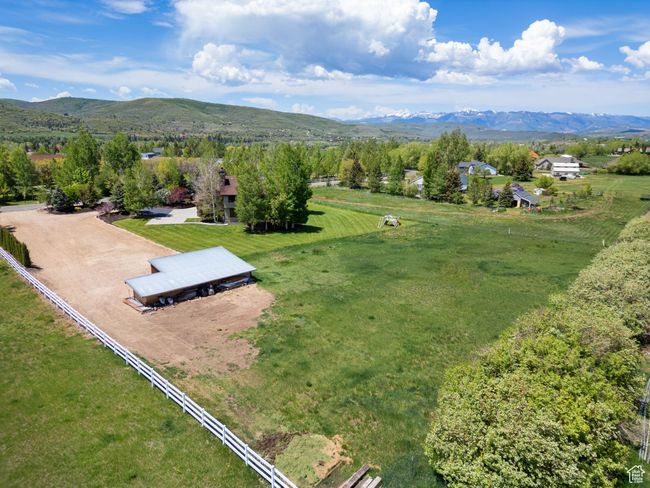 Aerial view of sparsely populated area with a mountainous background | Image 76