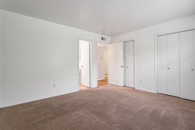 Bedroom featuring multiple closets and carpet floors | Image 16