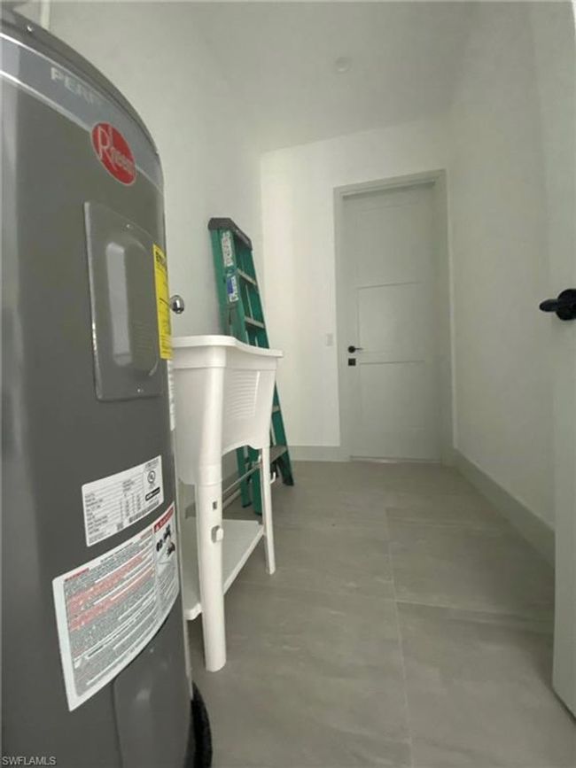 Utility room features Washer and Dryer/Wash Basin/Wather Heater | Image 19