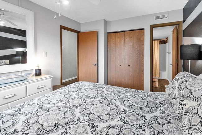 Bedroom featuring a closet, ceiling fan, and visible vents | Image 8