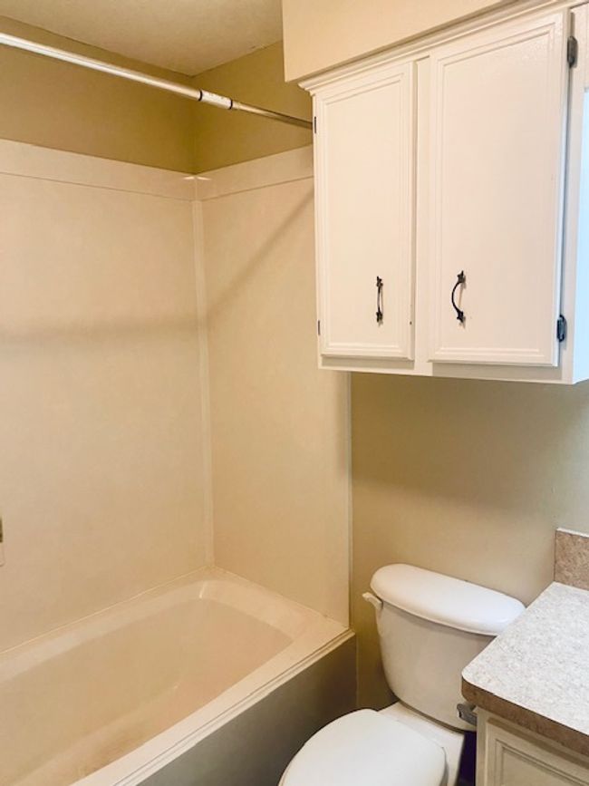 Bathroom featuring toilet, bathtub / shower combination, and vanity | Image 14