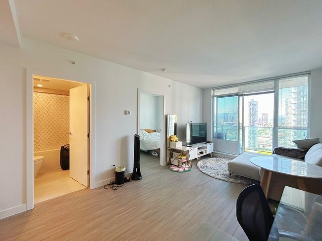 Living room featuring light wood-type flooring and baseboards | Image 8