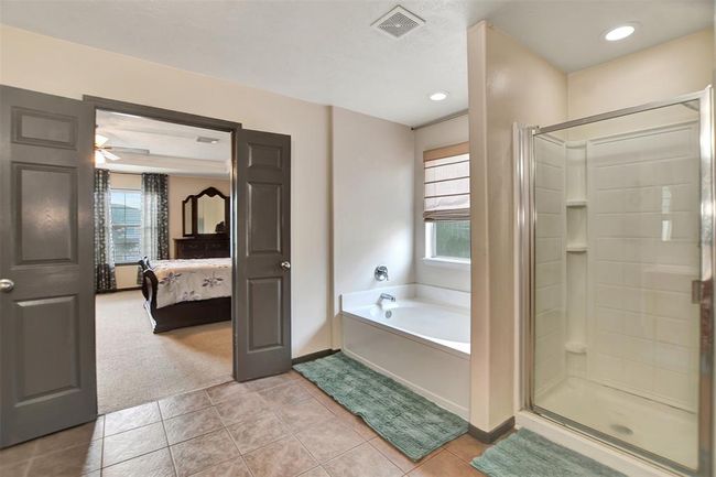 Enjoy a luxurious shower and a separate soaking tub for ultimate relaxation. | Image 37