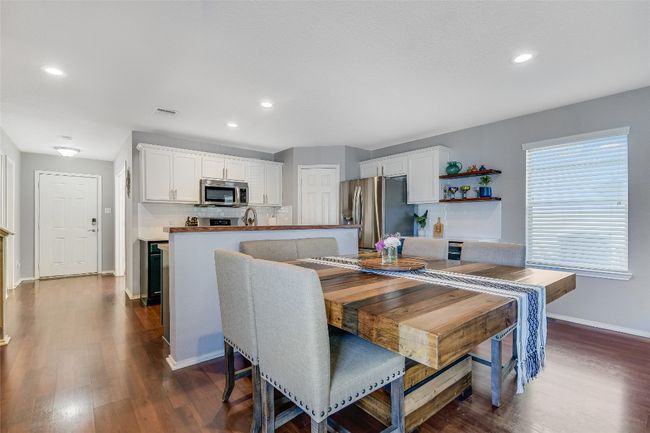 Dining room featuring dark wood-type flooring and recessed lighting | Image 7