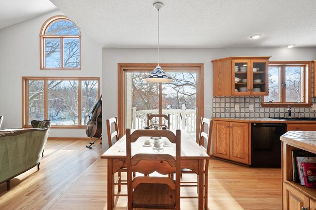 The kitchen and dining space are filled with natural light from the morning sun. | Image 9