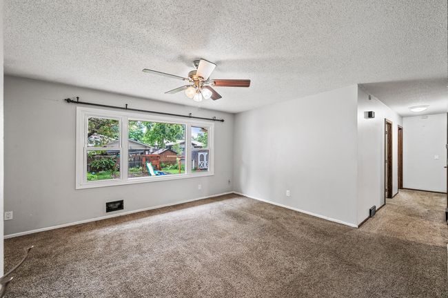 Living room. Hallway on right to 3 bedrooms. | Image 4