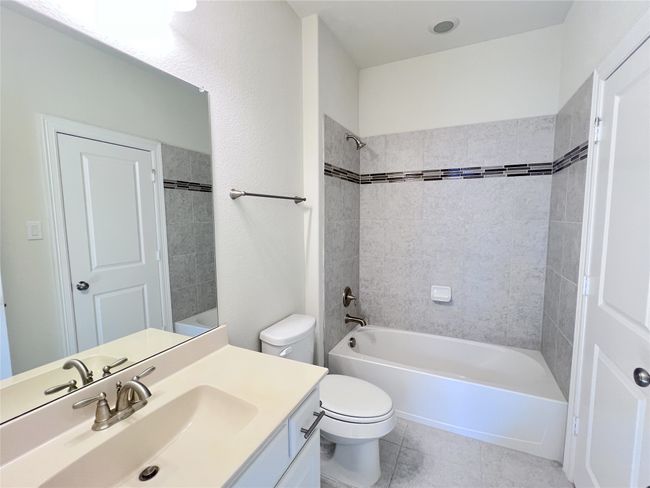 Full bath with vanity, bathing tub / shower combination, and tile patterned flooring | Image 35