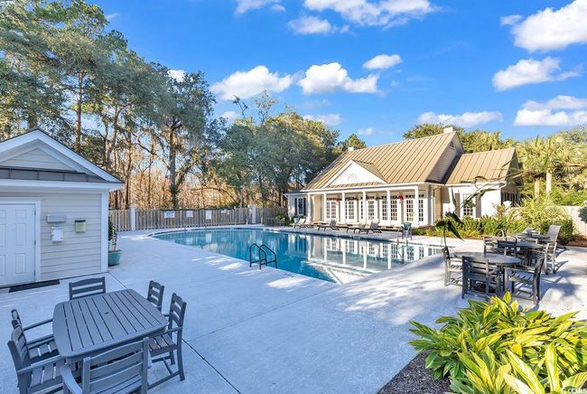 Community pool with a patio area and outdoor dining space | Image 36