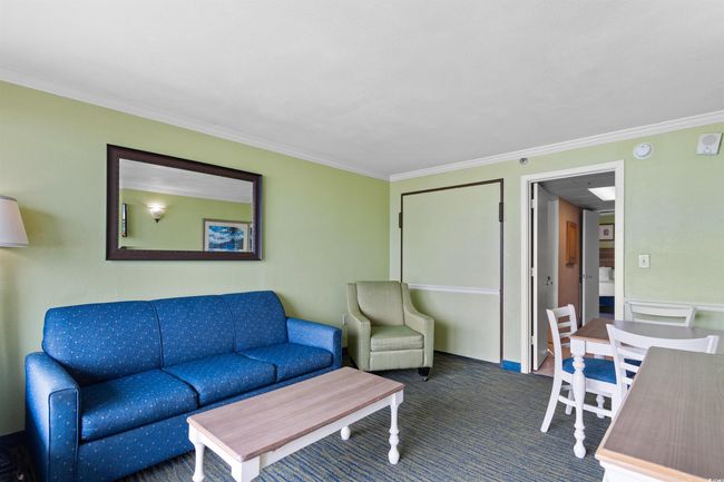 Carpeted living area with ornamental molding | Image 8