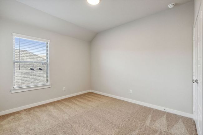 Spare room with carpet, baseboards, vaulted ceiling, and a smoke detector | Image 20