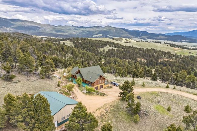 View from above of property featuring a mountainous background and a forest | Image 10
