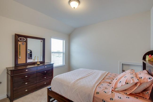 Bedroom featuring light colored carpet and lofted ceiling | Image 23