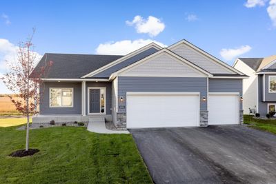 9853 32nd St NE- Home is ready for a quick move-in! Highlights include a spacious concrete front porch, unfinished lower level, stone accents, & Pella windows. | Image 1