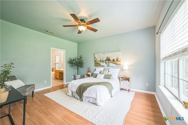 Large primary bedroom with huge windows, laminate flooring and dedicated ensuite. | Image 9