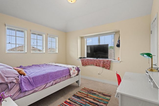 Carpeted bedroom featuring multiple windows and baseboards | Image 22