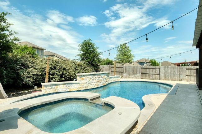 View of gunite swimming pool and connected hot tub | Image 26