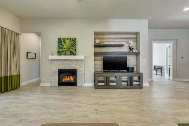 Living area with gas fireplace and sliding doors | Image 21