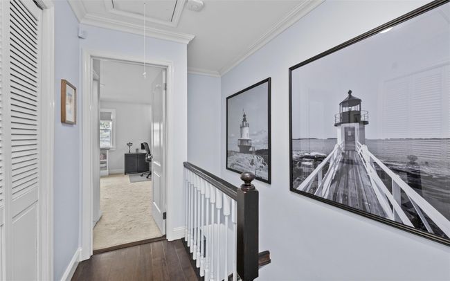 Hall featuring hardwood / wood-style floors, attic access, baseboards, and crown molding | Image 13