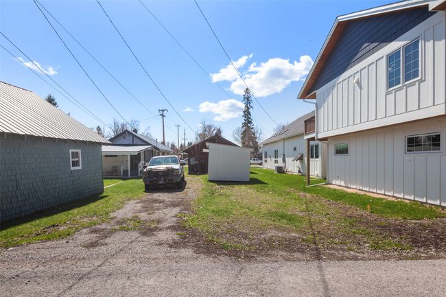 View of yard with dirt driveway | Image 29