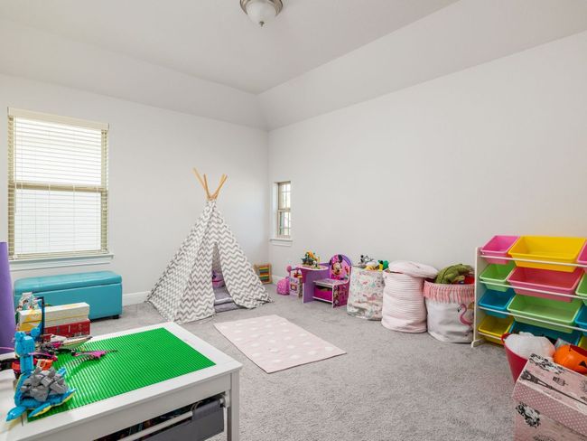 Playroom with baseboards, lofted ceiling, and carpet | Image 25