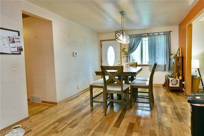 Dining area featuring light wood finished floors and baseboards | Image 11