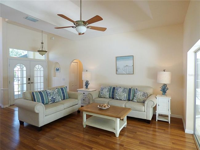 living room has tray ceiling with fans | Image 18