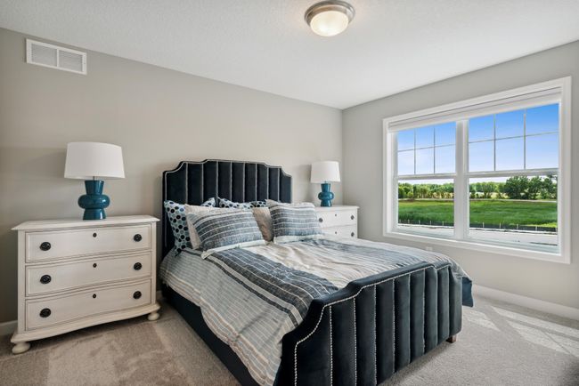 (Photo of decorated model, similar floor plan, colors, finishes and features will vary) The third generously sized upper level bedroom with a spacious closet. Plus, an en-suite 3/4 bathroom is connected. | Image 19