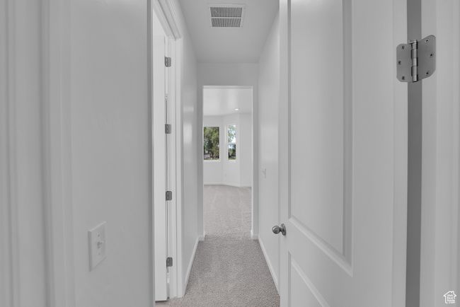 Corridor with light carpet and baseboards | Image 23