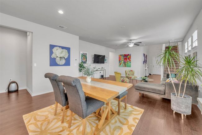 Dining area featuring wood finished floors, a ceiling fan, recessed lighting, and baseboards | Image 4