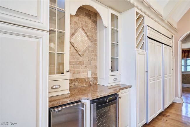 In the kitchen is built in wine cooler, ice maker, and subzero refrigerator | Image 9