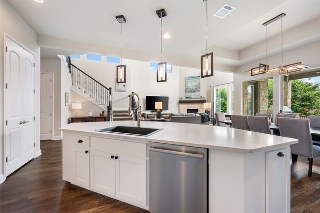 Kitchen with stainless steel dishwasher, open floor plan, plenty of natural light, light countertops, and recessed lighting | Image 15