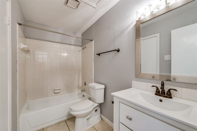 Bathroom featuring vanity, washtub / shower combination, and tile patterned floors | Image 14