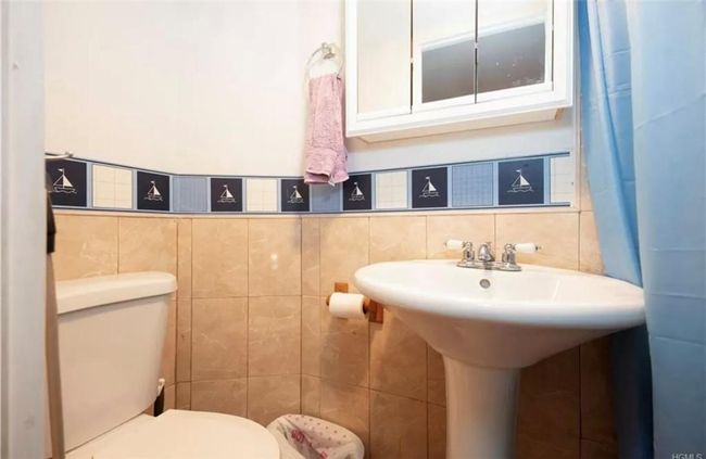 Bathroom featuring backsplash, toilet, and tile walls | Image 12